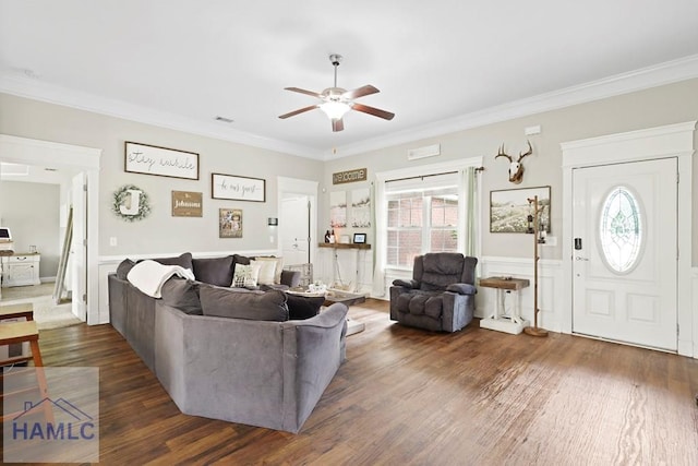 308 Mancey Garrason Loop NE, Ludowici, GA 31316 - living room with a ceiling fan, dark wood-style floors, crown molding, healthy amount of natural light, and a wainscoted wall