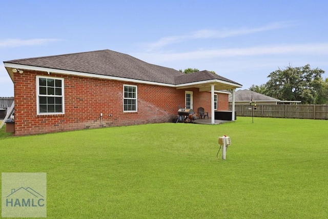 308 Mancey Garrason Loop NE, Ludowici, GA 31316 - rear view of property with a patio area, brick siding, and roof with shingles