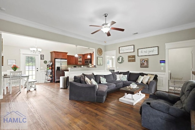 308 Mancey Garrason Loop NE, Ludowici, GA 31316 - living room featuring a ceiling fan, dark wood-type flooring, crown molding, a chandelier, and a wainscoted wall