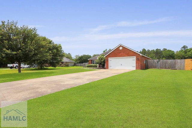 308 Mancey Garrason Loop NE, Ludowici, GA 31316 - view of front facade with driveway, brick siding, and an attached garage
