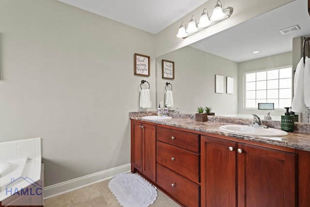308 Mancey Garrason Loop NE, Ludowici, GA 31316 - full bathroom featuring double vanity, baseboards, a garden tub, and tile patterned floors