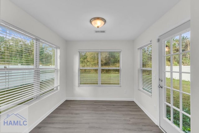 unfurnished sunroom featuring a wealth of natural light