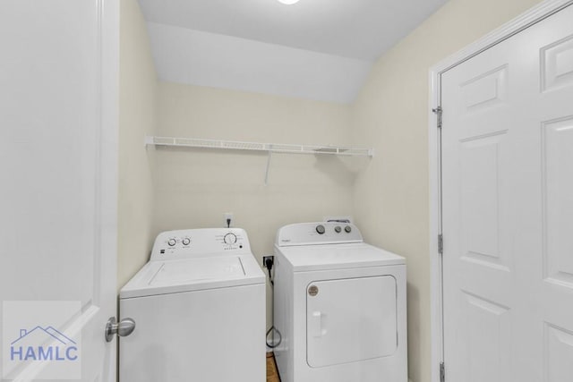 clothes washing area featuring washer and clothes dryer