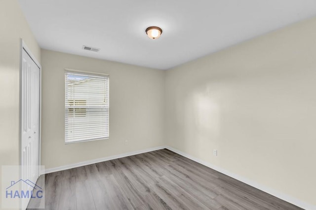 empty room with light hardwood / wood-style flooring