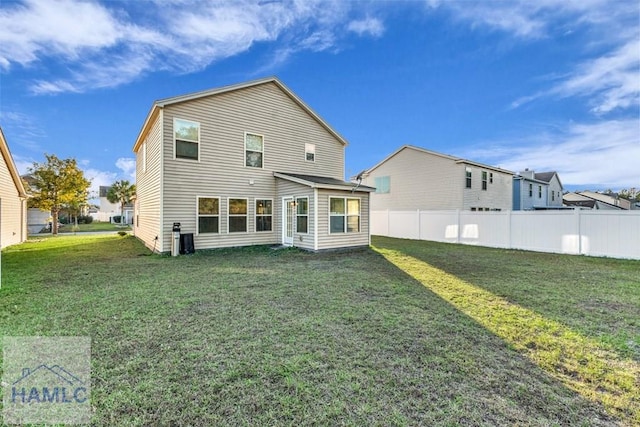 rear view of property with a yard