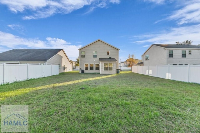 back of house with a lawn