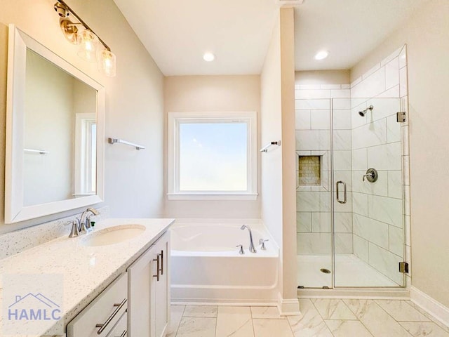 bathroom with vanity and independent shower and bath