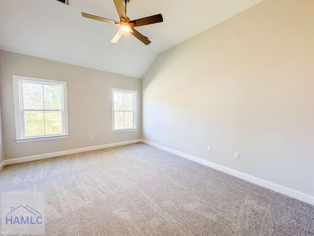 carpeted spare room with vaulted ceiling and ceiling fan