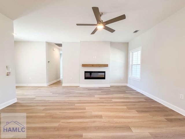 unfurnished living room with ceiling fan and light hardwood / wood-style floors