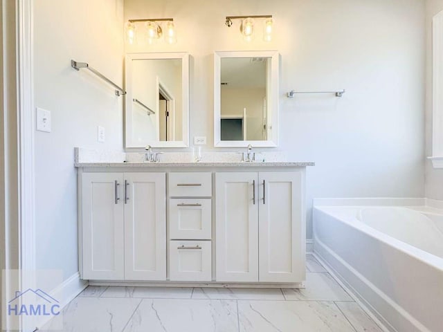 bathroom featuring vanity and a washtub