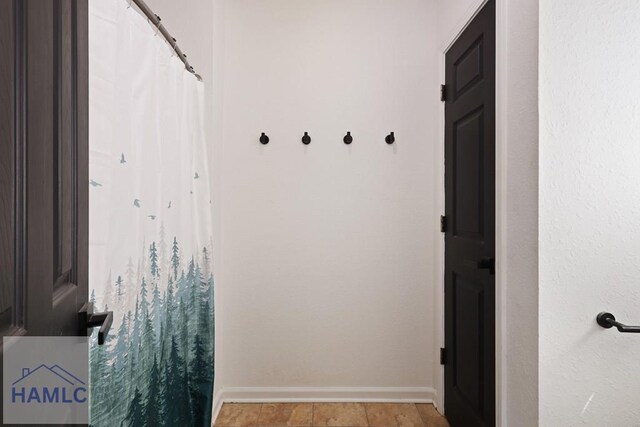 413 E Banks St, Glennville, GA 30427 - bathroom with baseboards and a shower with shower curtain