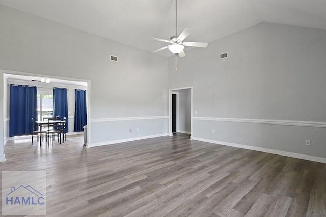 413 E Banks St, Glennville, GA 30427 - unfurnished living room with high vaulted ceiling, a ceiling fan, wood finished floors, and baseboards