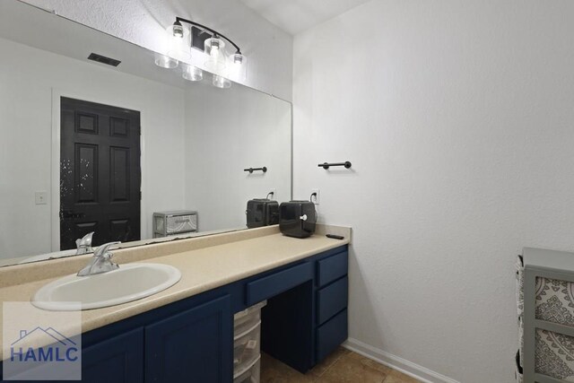413 E Banks St, Glennville, GA 30427 - bathroom featuring vanity, baseboards, and tile patterned flooring