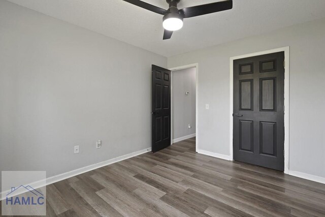 413 E Banks St, Glennville, GA 30427 - unfurnished bedroom featuring wood finished floors, baseboards, and a ceiling fan