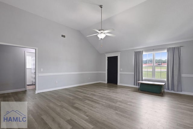 413 E Banks St, Glennville, GA 30427 - unfurnished living room featuring vaulted ceiling, ceiling fan, dark wood finished floors, and baseboards