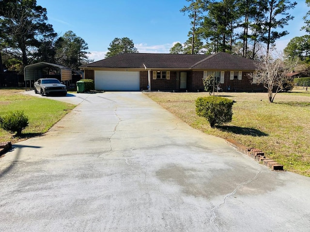 ranch-style home featuring a garage, a front yard, and a carport