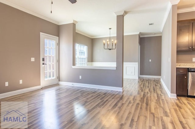 interior space with light wood finished floors, crown molding, light countertops, ceiling fan with notable chandelier, and stainless steel dishwasher