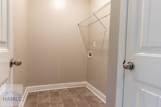 washroom with baseboards, washer hookup, and laundry area