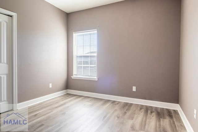 unfurnished room featuring light wood-style flooring and baseboards