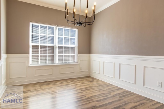 unfurnished dining area with plenty of natural light, a chandelier, and crown molding