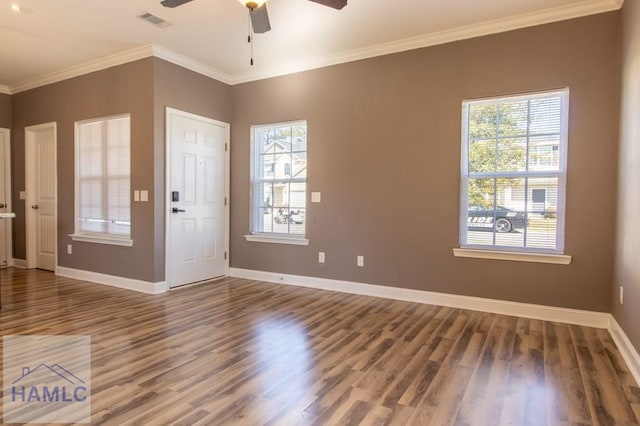 foyer entrance featuring wood finished floors, baseboards, visible vents, ornamental molding, and ceiling fan