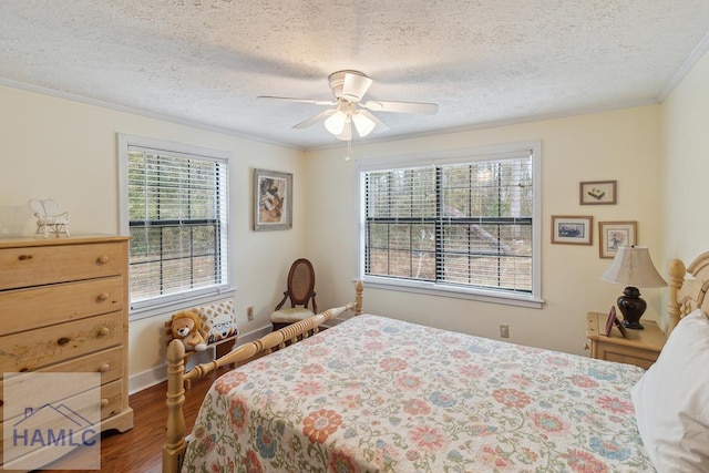 bedroom featuring hardwood / wood-style flooring, ornamental molding, a textured ceiling, and ceiling fan