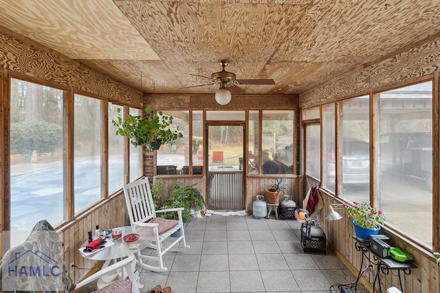 unfurnished sunroom with wood ceiling and ceiling fan