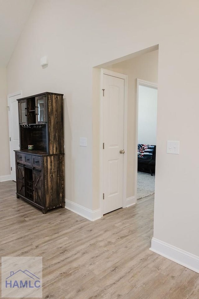 unfurnished living room featuring light hardwood / wood-style flooring and high vaulted ceiling