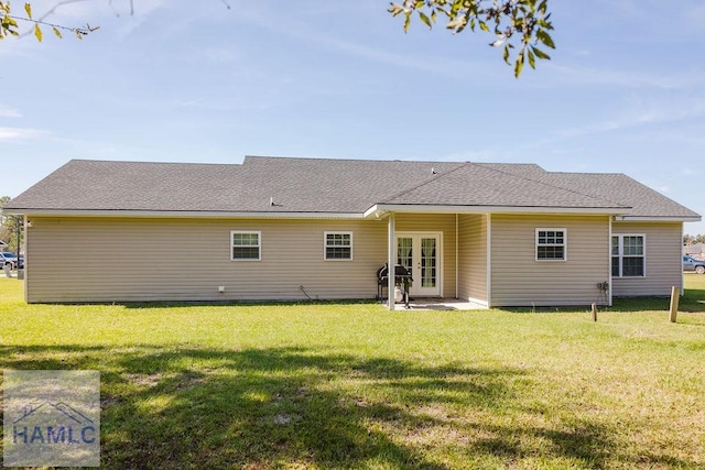 rear view of property featuring a lawn