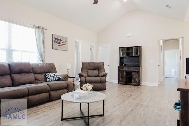 living room featuring light wood-type flooring, high vaulted ceiling, and ceiling fan