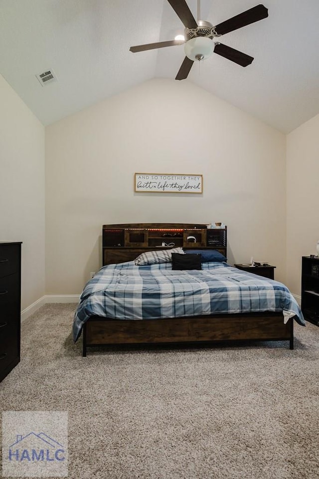 carpeted bedroom with ceiling fan and vaulted ceiling