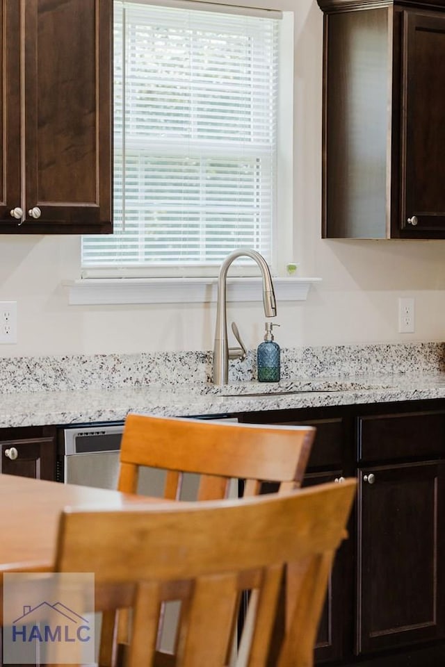 kitchen with dark brown cabinetry and sink