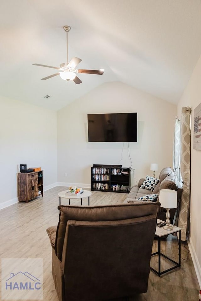 living room featuring light hardwood / wood-style flooring, vaulted ceiling, and ceiling fan