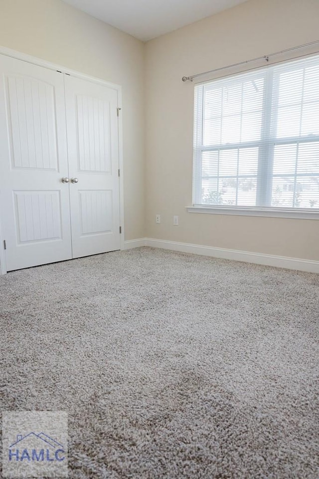 unfurnished bedroom with a closet and carpet