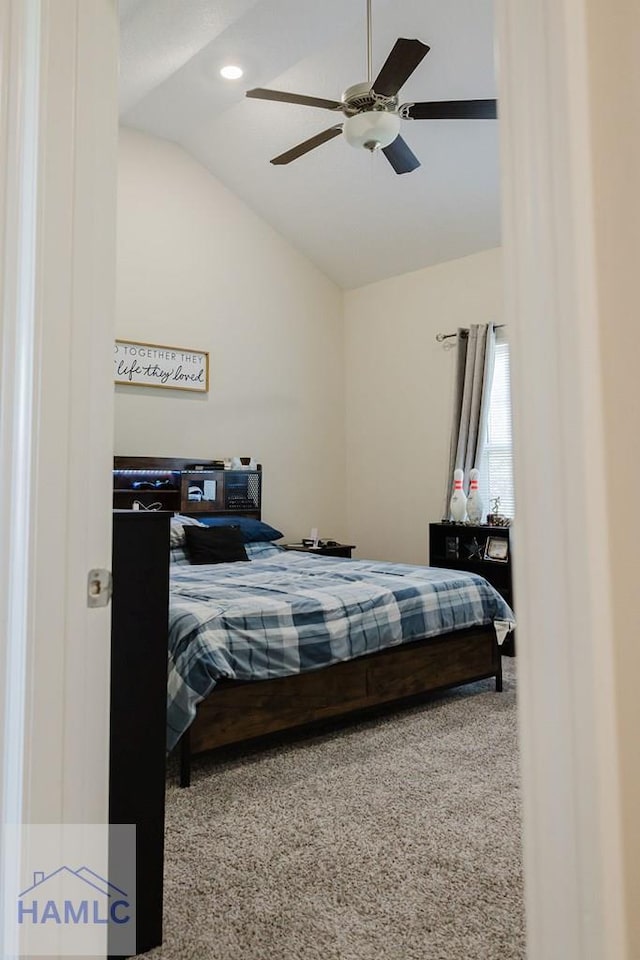 carpeted bedroom with ceiling fan and lofted ceiling