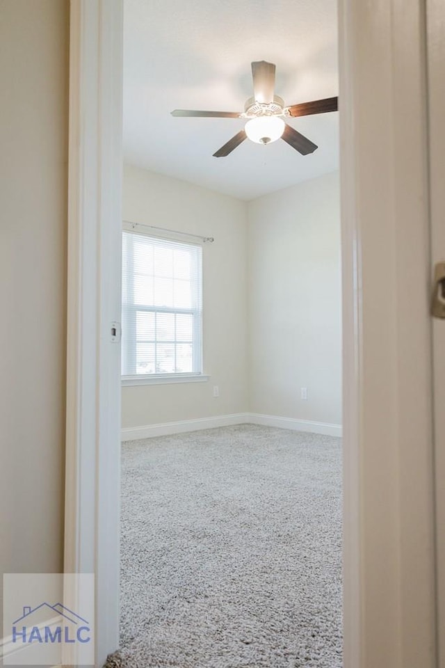 carpeted empty room featuring ceiling fan