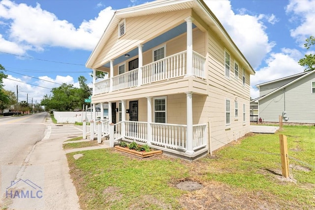 1514 Augusta Ave, Savannah, GA 31415 - view of front of home featuring a front yard, covered porch, and a balcony