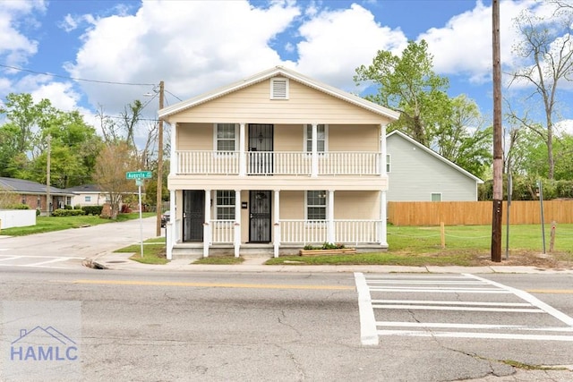 1514 Augusta Ave, Savannah, GA 31415 - view of front of property with covered porch, fence, a front lawn, and a balcony