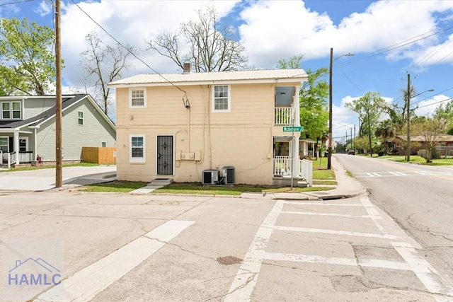 1514 Augusta Ave, Savannah, GA 31415 - view of front of home featuring metal roof, a balcony, and cooling unit