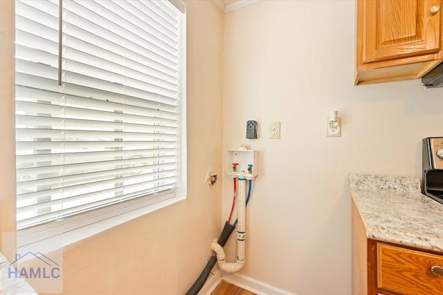 1514 Augusta Ave, Savannah, GA 31415 - laundry room featuring baseboards and cabinet space