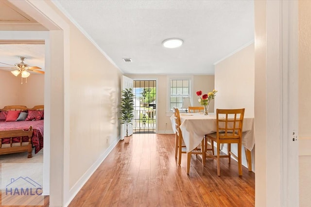 1514 Augusta Ave, Savannah, GA 31415 - dining area featuring a ceiling fan, light wood finished floors, baseboards, and ornamental molding