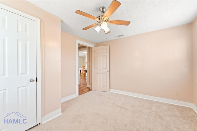1514 Augusta Ave, Savannah, GA 31415 - unfurnished bedroom featuring visible vents, baseboards, ceiling fan, a textured ceiling, and carpet flooring