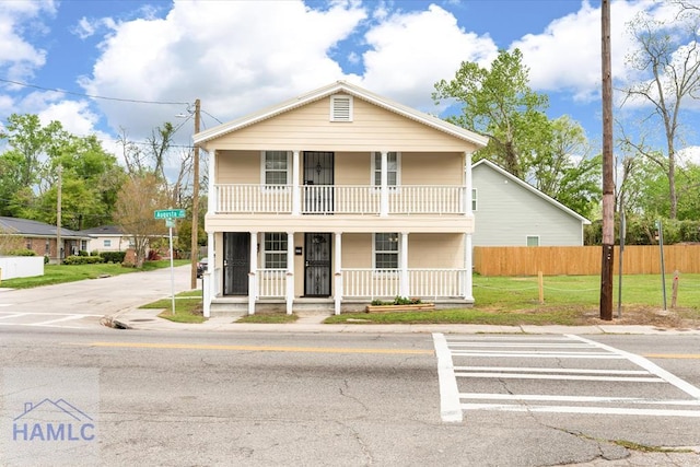 1514 Augusta Ave, Savannah, GA 31415 - view of front of property with a front yard, a balcony, fence, and covered porch