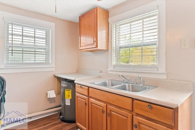 1514 Augusta Ave, Savannah, GA 31415 - kitchen with light countertops, dark wood-style flooring, and a sink