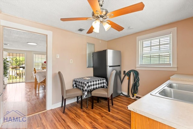 1514 Augusta Ave, Savannah, GA 31415 - dining room featuring light wood-style floors, ceiling fan, visible vents, and a textured ceiling