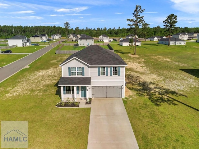 247 Morgan Field Blvd, Ludowici, GA 31316 - traditional home featuring a garage, driveway, a front yard, and covered porch