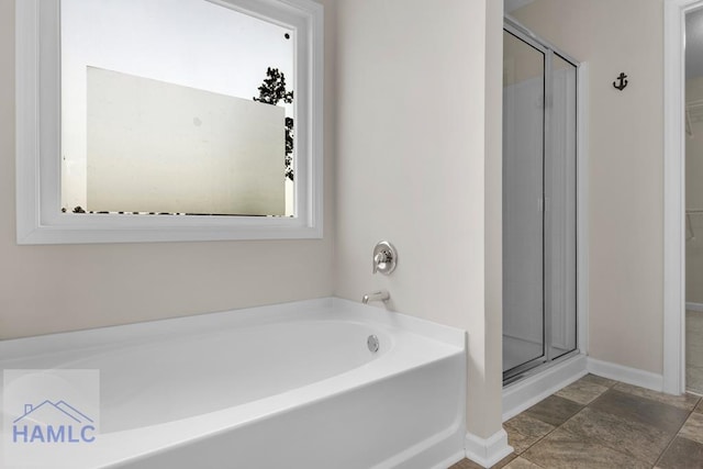 247 Morgan Field Blvd, Ludowici, GA 31316 - bathroom featuring a garden tub, a shower stall, and baseboards