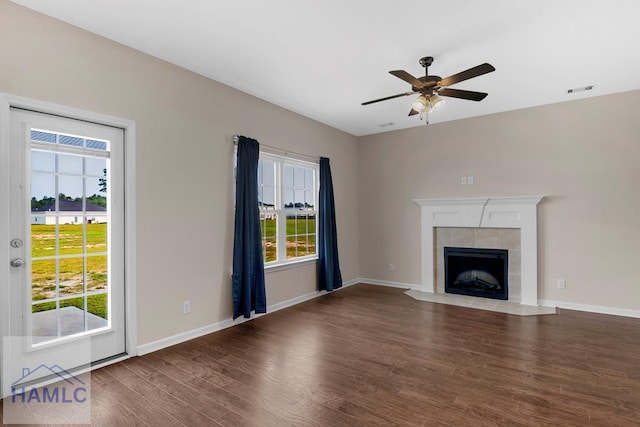 247 Morgan Field Blvd, Ludowici, GA 31316 - unfurnished living room featuring wood finished floors, healthy amount of natural light, a ceiling fan, and a fireplace