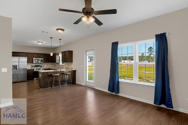 247 Morgan Field Blvd, Ludowici, GA 31316 - kitchen with stainless steel appliances, dark brown cabinetry, light countertops, and dark wood finished floors