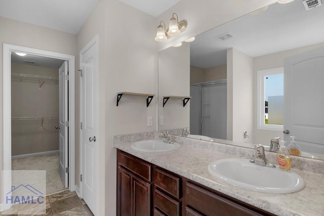247 Morgan Field Blvd, Ludowici, GA 31316 - full bath featuring double vanity, a walk in closet, a shower, and baseboards